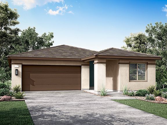 A single-story, beige-colored house with a brown tiled roof sits in a well-landscaped yard surrounde