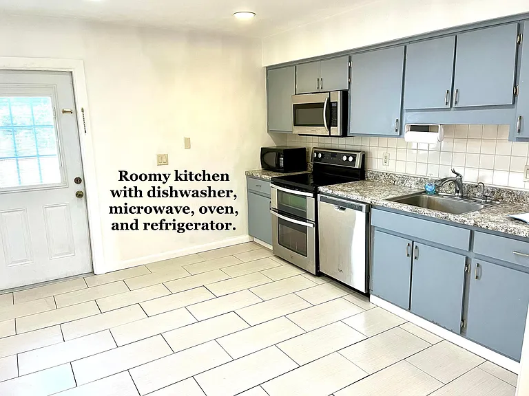 Kitchen with stove, dishwasher, microwave, and refrigerator
