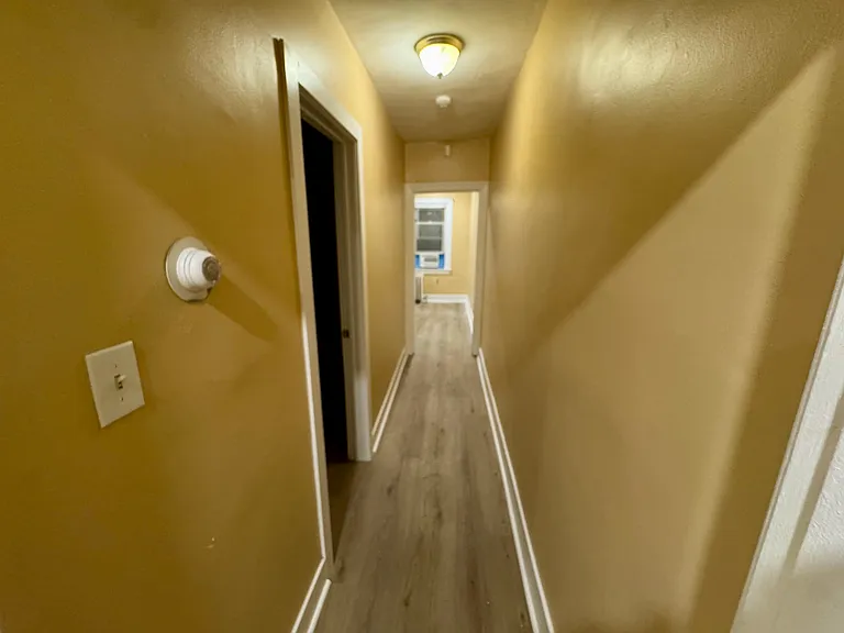 Hallway to bedroom and kitchen