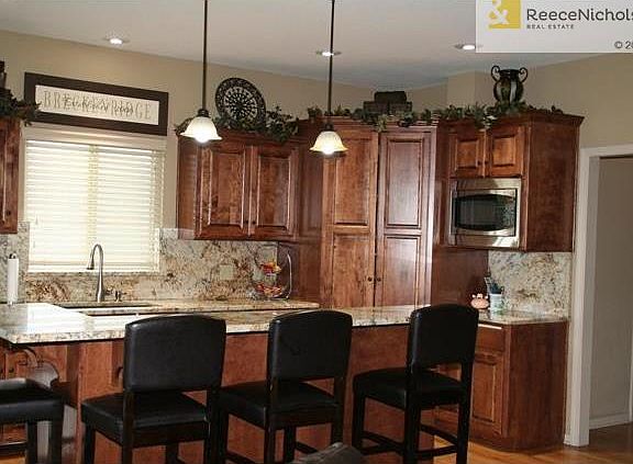 Beautiful granite counter tops and backsplash.  Kitchen features 5 burner cook top, walk in pantry and NEW GE dishwasher, new sink and faucet.