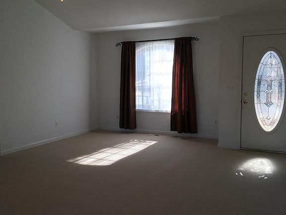 Living room, front door, big enough for dining area in front of window