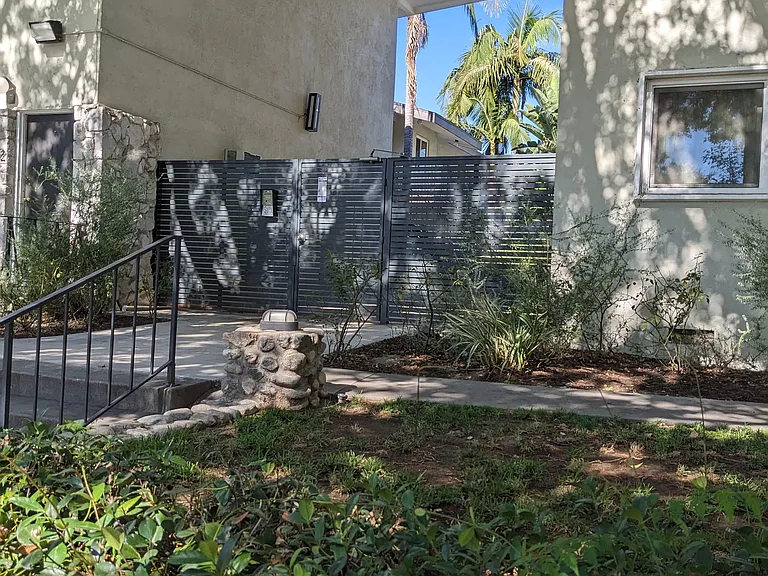 Privacy gate to innear courtyard, pool, and apartment enterances at Los Robles Apartments in Pasadena, California.