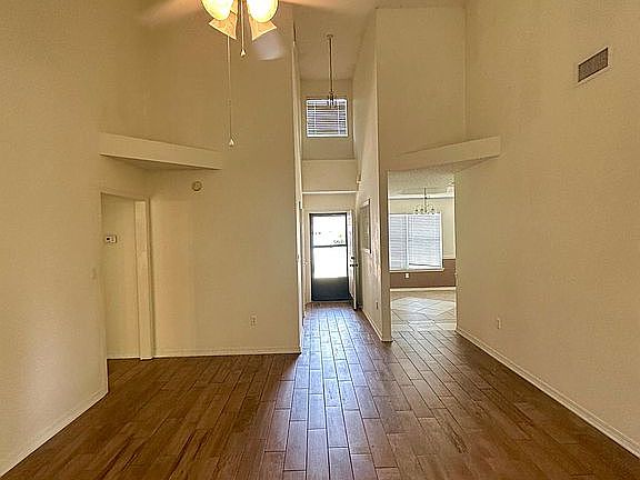 Entryway to living and kitchen with wood floors