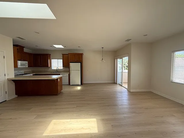 Living room, dining room, kitchen from hallway