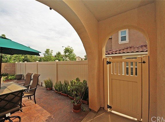 Gated patio entryway under wide arch