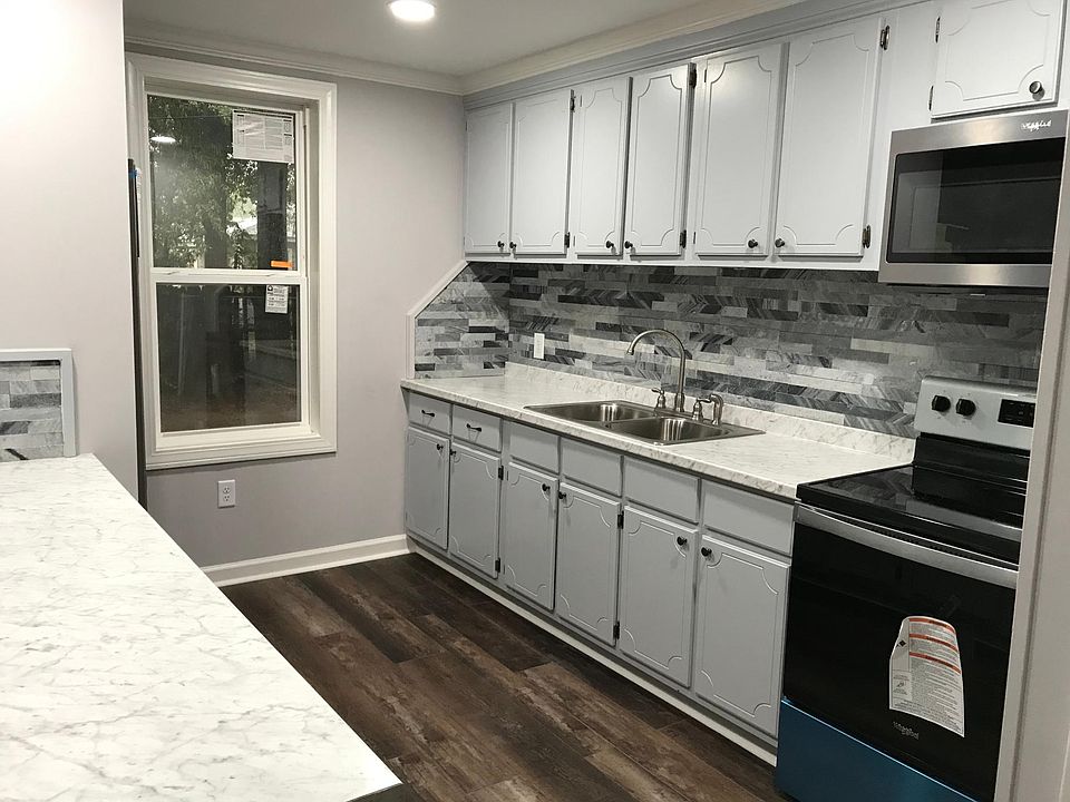 New kitchen cabinets with new kitchen appliances and new laminated floors