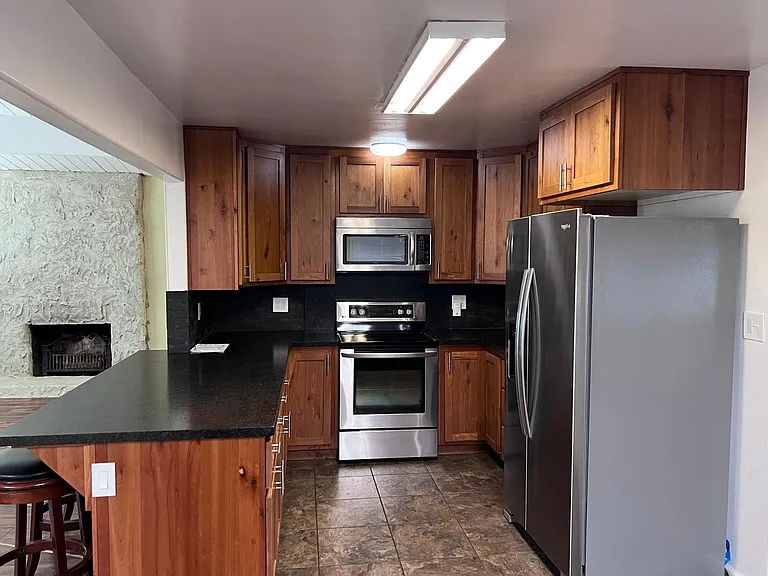 Kitchen- Standing in front of sink cabinet