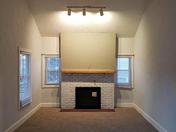 Spacious living room with fireplace and vaulted ceiling