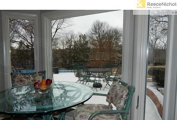 View from eating area in the kitchen to the pool and patio.
