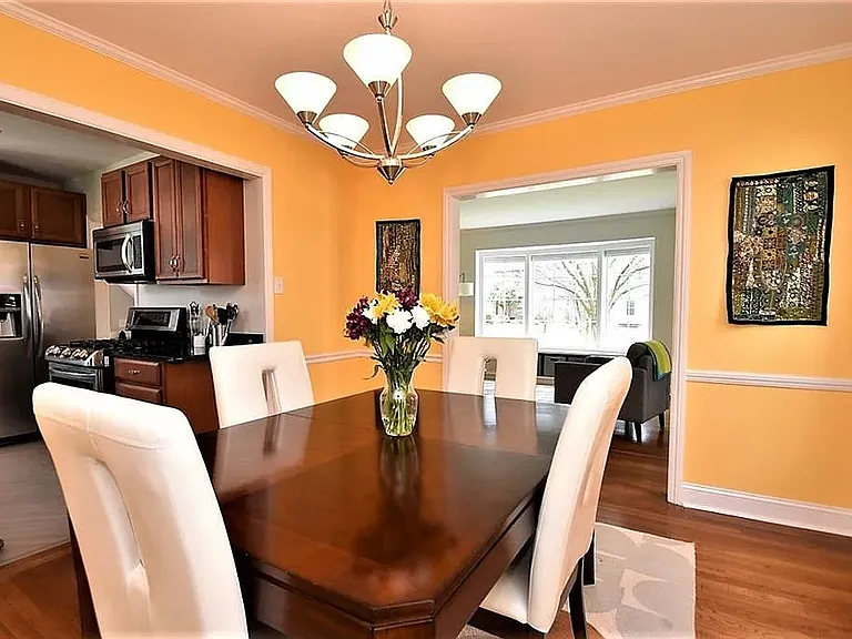 Dining room with the kitchen to the left and the family room in the distance