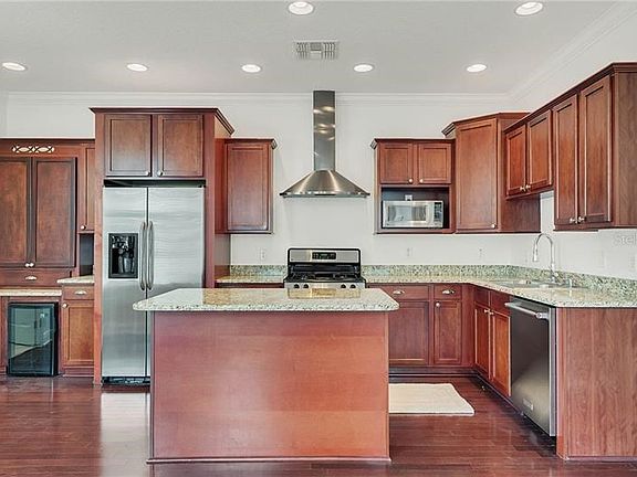 Gorgeous kitchen with center island and stainless steel appliances.