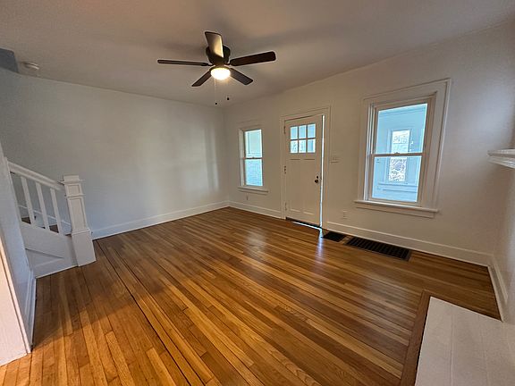 Living room with non-functioning fireplace and mantle