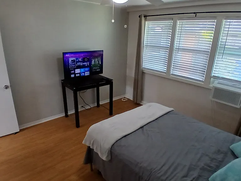 Furnished bedroom with TV and Internet.