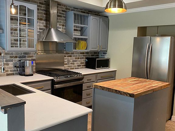 Kitchen (measures 12' x 13') has been completely updated with tray ceilings, quartz countertops and recessed LED lighting. and includes new 30"gas range, Bosch dishwasher and French door refrigerator and wall size pantry. (shades for pendents over sink