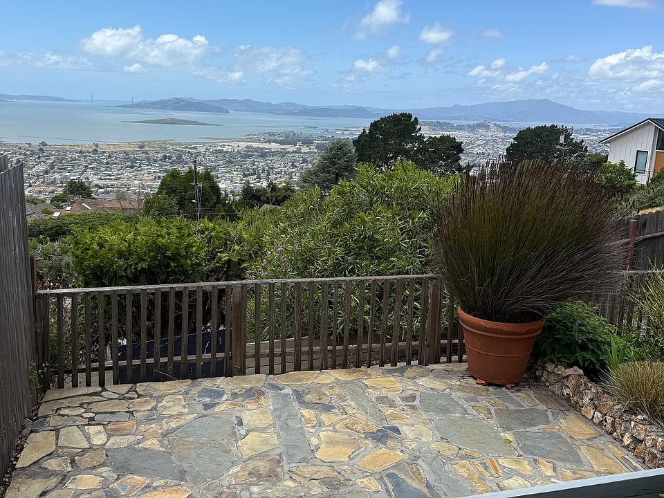 view of the bay from the front door...patio, bench, the edge of the garden