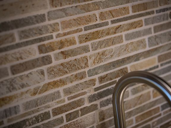Kitchen sink with brick backsplash