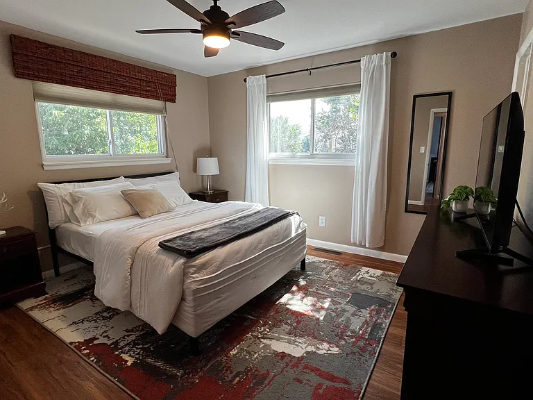 Primary bedroom with a comfortable queen bed and two spacious closets for extended-stay storage.