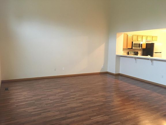Wood laminate flooring & soaring ceilings in great room