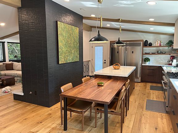 Kitchen from foyer looking to deck. Deck access via door on far wall