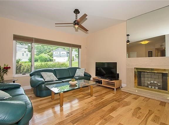 Large Living Room with cathedral ceiling, fireplace and hickory floor.