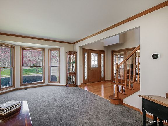 Spacious living room freshly painted, newer carpeting, crown molding.