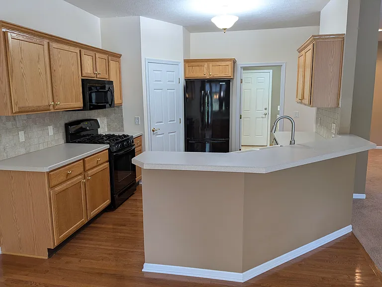 Kitchen with walk in pantry and all appliances--gas stove, refrigerator, microwave, and dish washer.