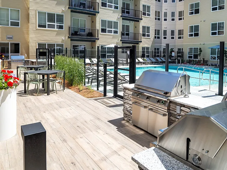 Outdoor courtyard #1 including pool, sundeck, and bbq grills