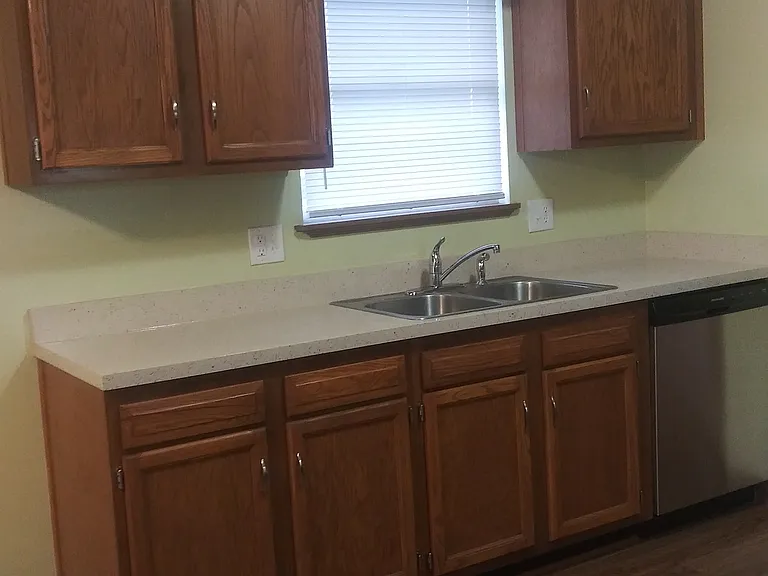 Right view of the kitchen which includes a brand new stainless steel dishwasher.