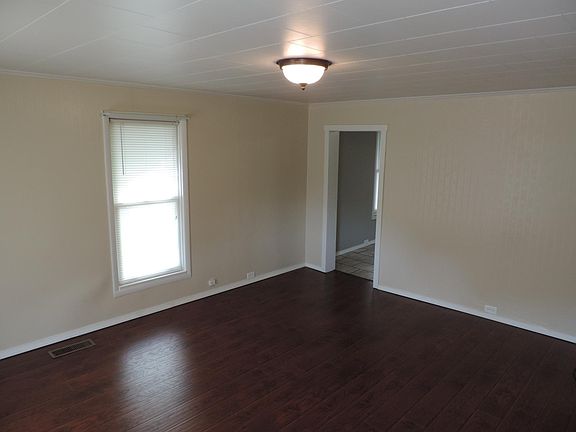 Spacious living room with new wood floors.