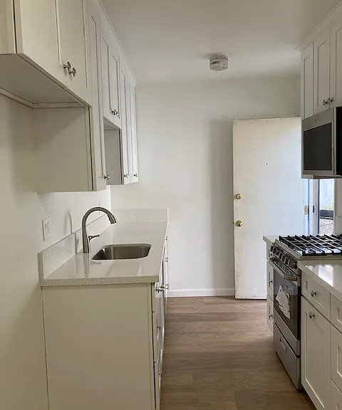 Back door to the kitchen is directly across from the laundry room.