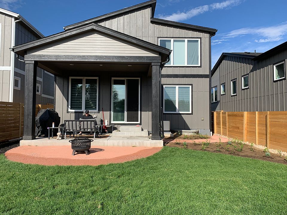 Rear patio and spacious fenced in backyard