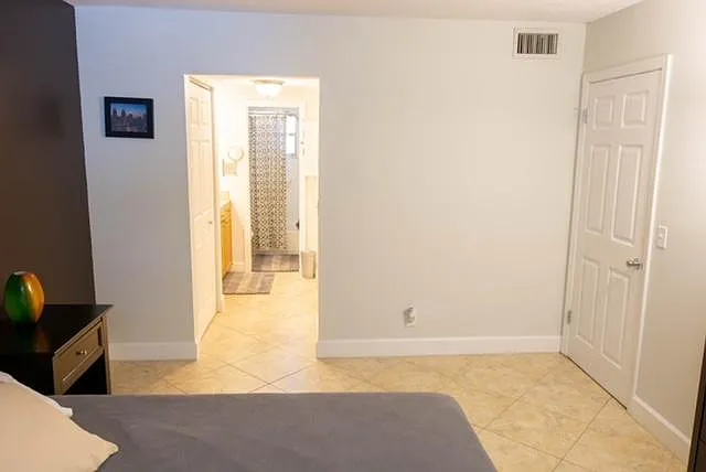 The doorway between the bathroom and bedroom closes with a newly installed barn door (not pictured here).
