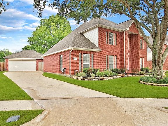 The long driveway leads to the detached 2-1/2 car garage.