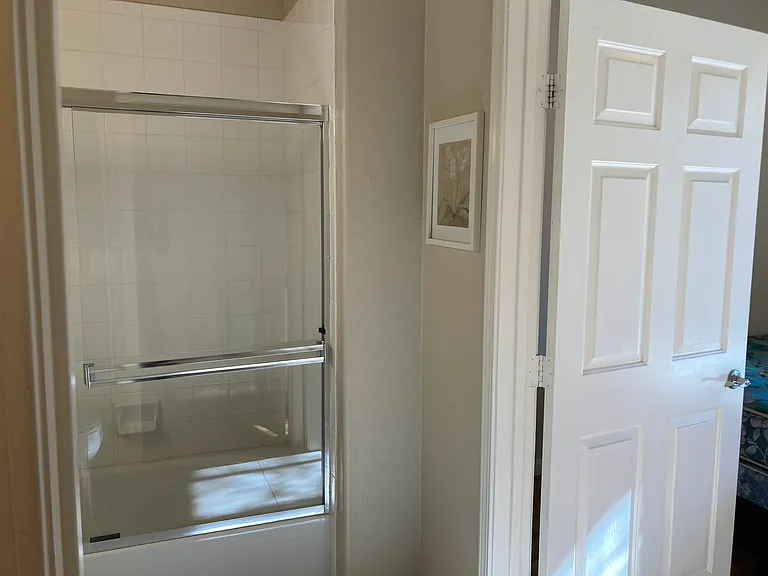 Bathroom door shows bath is attached to Second Bedroom with one door and to hallway with other door so it can be used by guests.