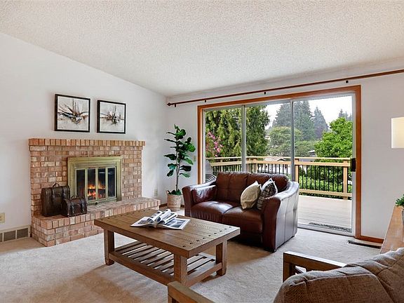 Inviting great room with a wall of sliders to the newly painted wood deck perfect for entertaining.