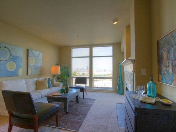 Freshly repainted and carpeted the living room boasts floor to ceiling windows, a gas fireplace and access to the deck. Great views, night and day!