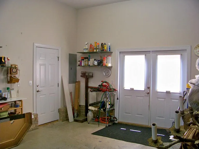 heated cooled workshop-work out room with double doors to back sidewalk