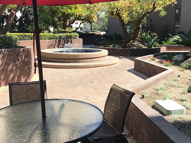 Stop and read at garden tables in the main plaza
