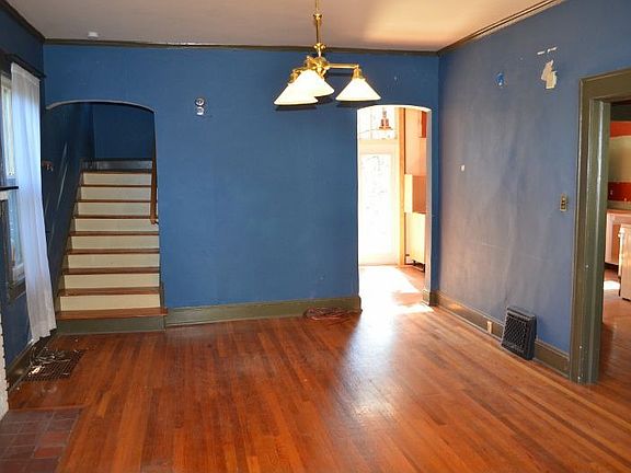 Hardwood floors, large period moldings, and hardwoods throughout.