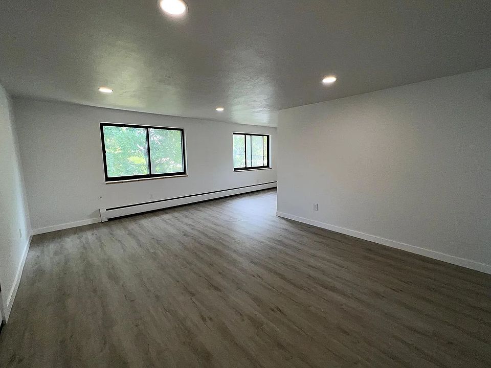 Large, light dining and living area with wood floors.