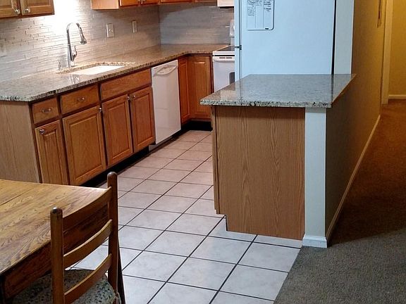 Kitchen with granite counters, newer appliances, eating area.