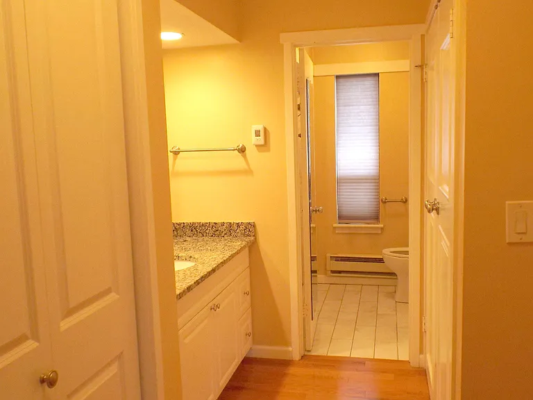 Vanity, sink and laundry are just outside the bathroom.