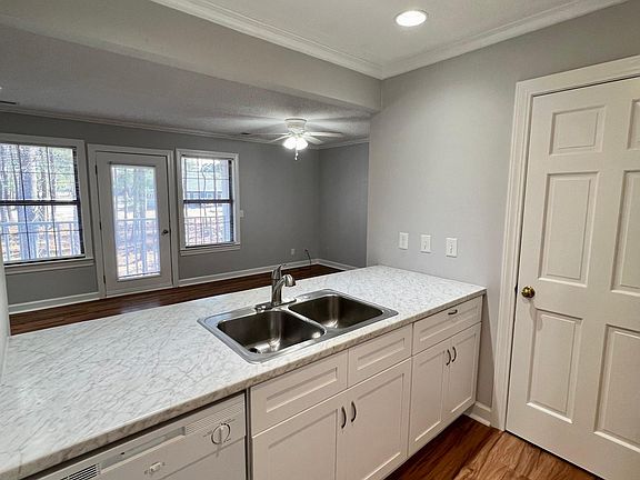 Kitchen features bar seating and open view to living room.