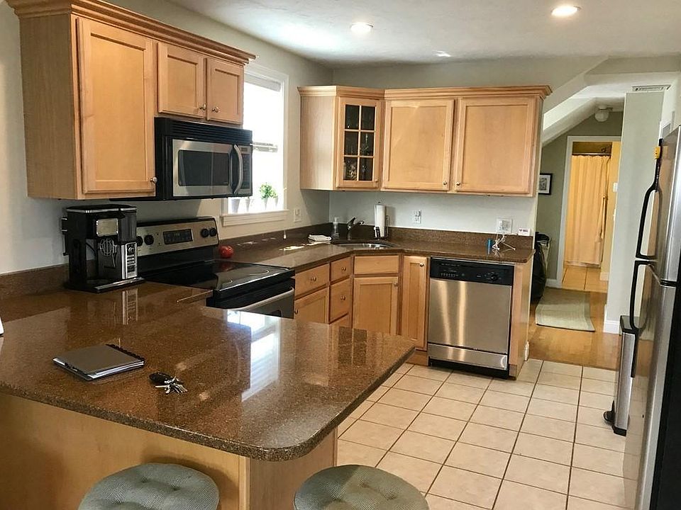 Modern kitchen with stainless steel appliances and granite countertops.