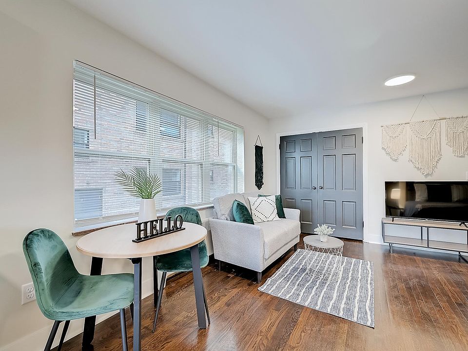 Main living space featuring refinished hardwood floors and new windows. Will be unfurnished. Multiple unit floorplans available.