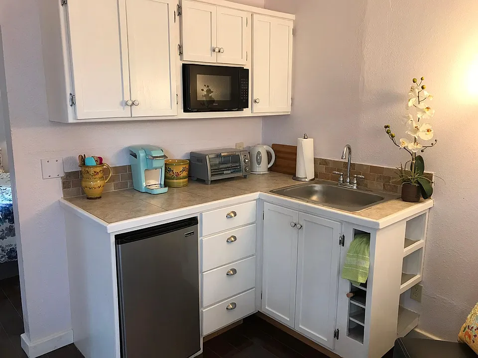 Kitchenette includes microwave, studio refrigerator, toaster oven, hot plate, Keurig and tea kettle. Plates/glasses and linens