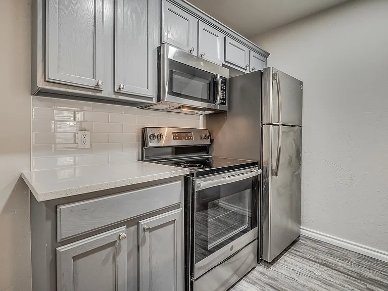 Experience culinary delights in this sleek, modern kitchen outfitted with top-of-the-line stainless steel appliances.