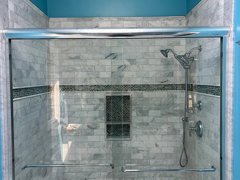 Primary bathroom with oversized custom walk-in shower and sky light.