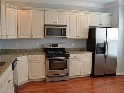 Main floor Kitchen hardwood floors and granite counter tops, stainless appliances including microwave, dishwasher, refrigerator, gas stove, disposal.