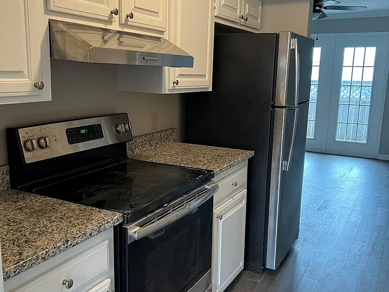 Galley style kitchen with all appliances and granite counter tops